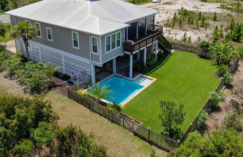 Port St. Joe House | Summer Bay, a beautiful Bay View Home private backyard oasis around the swimming pool, screened porch, and sundeck