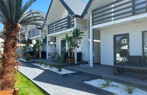 Rusinowo Cabin | Sunny Baltic: Oceanfront Spa Retreat with Child-Friendly Amenities