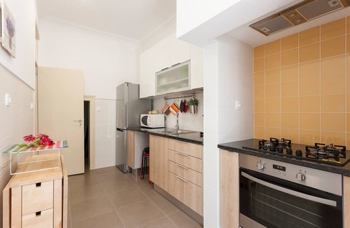 Penha de Franca Apartment | Bright Orange Garden Apartment in Central Lisbon - Rated 10/10