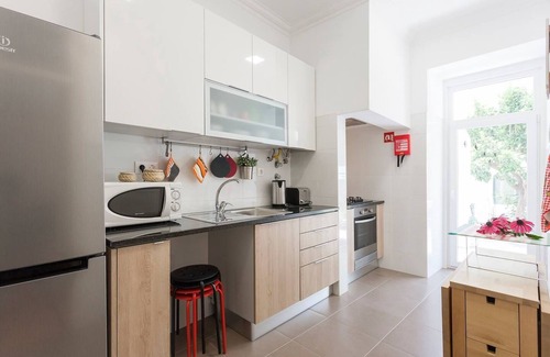 Penha de Franca Apartment | Bright Orange Garden Apartment in Central Lisbon - Rated 10/10
