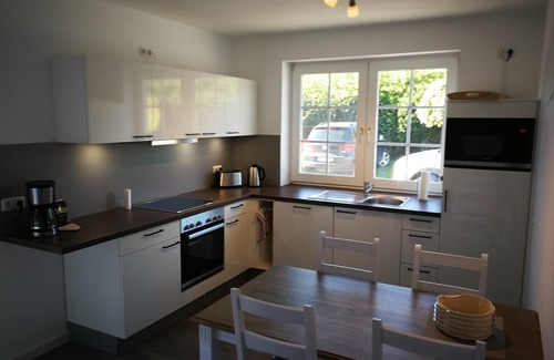 Albertsdorf Apartment | Sunny Sundblick accommodation with garden, terrace and wood-burning stove on Fehmarn