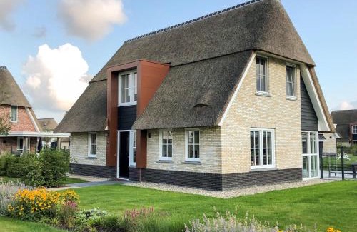 Delfstrahuizen Villa | Tranquil Thatched Villa by the Water with Family Amenities