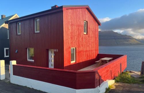 Faroe Islands House | Inviting Red House with Breathtaking Sea View for Families
