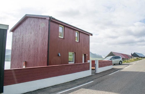 Faroe Islands House | Inviting Red House with Breathtaking Sea View for Families