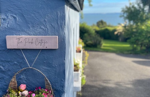 Carrickfergus Cottage | Enchanting Pink Cottage Suite with Ocean View & Secret Garden