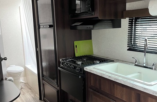 Aurora RV Rental | Cozy Tiny House on Wheels with Kitchen & Breakfast Included