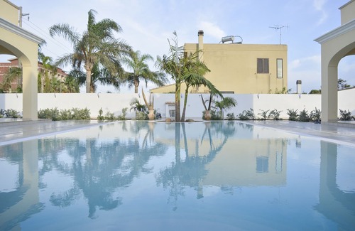 Mazara del Vallo Apartment | Relax at Tortuga3: Nighttime Pool and Oceanfront Views