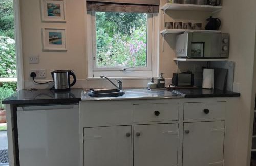 Goldsithney House | Serene Wood Cabin Nestled in a Picturesque Orchard