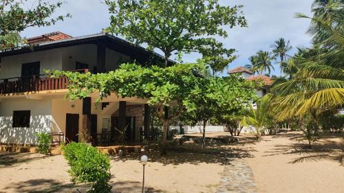 Tangalle House | Inviting Tropical Garden: Oceanfront Stay with Pool Access