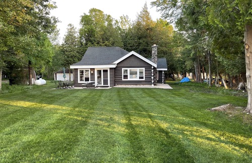 Petoskey Cabin | Pet-Friendly Log Cabin Retreat with Lake Views & Hot Tub