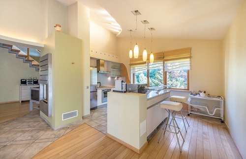 Business District Villa | Villa EverGreen: Downtown Retreat with Private Garden & Hot Tub
