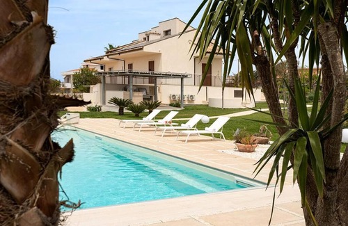 Modica Apartment | Villa Paradiso: Poolside Oasis with Ocean Views & Fireplace