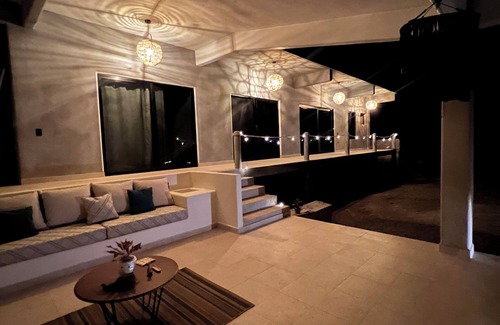 Troncones Bed & Breakfast | Warm room with the sea in the background and starry skies.