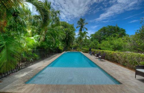 Captiva House | Inviting Waterfront Pink House with Private Dock and Pool
