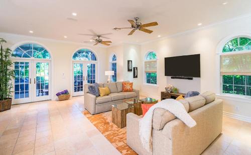 Captiva House | Inviting Waterfront Pink House with Private Dock and Pool