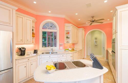 Captiva House | Inviting Waterfront Pink House with Private Dock and Pool