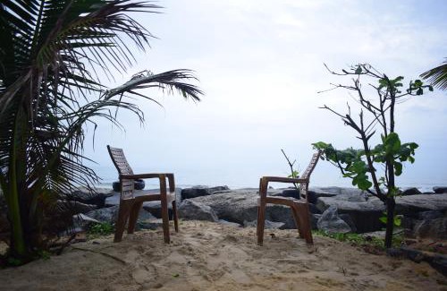 Tonse West House | Beachfront Bliss: Sea-Facing Rooms & Private Beach Access