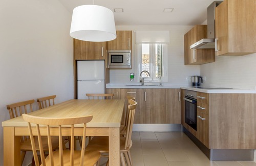 Arenal d'en Castell Apartment | Experience White Sands Beach Club: Top-Rated Oceanfront Escape