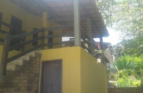 Lencois House | Tranquil Yellow House: Nestled Among the Trees