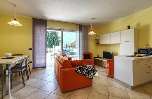 Gera Lario Apartment | Inviting Yellow Lake View: Poolside Escape for Families