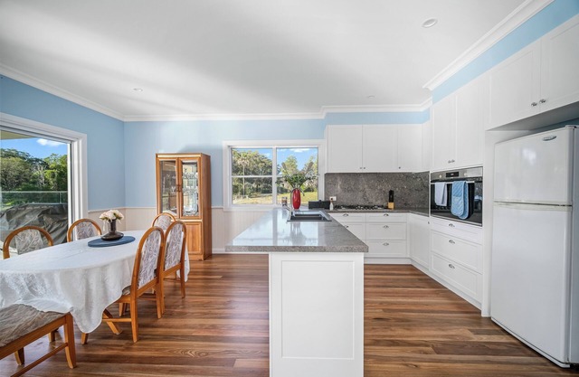A beautiful new 5 bedroom farmhouse with an in-ground pool surrounded by nature