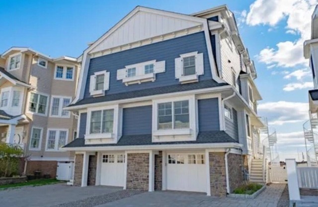 Avalon sunsets on the bay in this beautiful four-bedroom waterfront townhome.