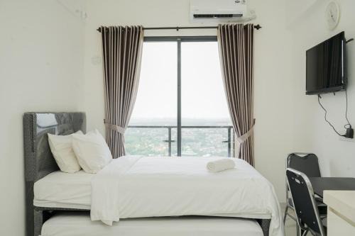 Cozy and Nice Studio at Sky House BSD Apartment By Travelio