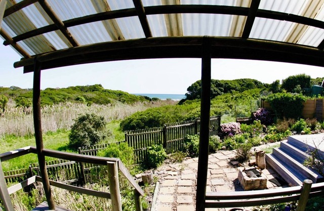 Cozy Retreat: 1-Bedroom with stunning sea view down serene green belt."