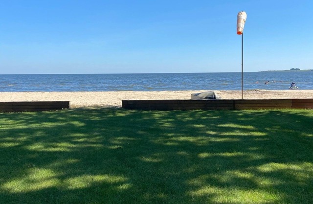 Cute house on Saginaw Bay with hot tub on private beach.