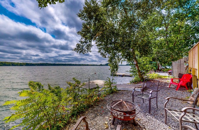 Dog-friendly lakefront home with dock, fireplace, firepit, lake views, & 1 kayak