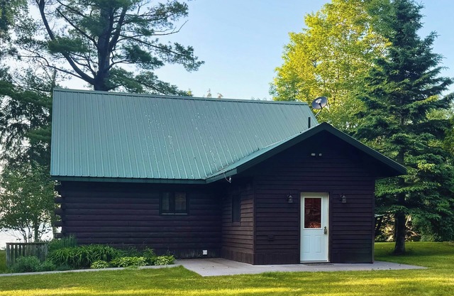 Escape to this peaceful cabin, perfectly situated directly on Huron Bay!