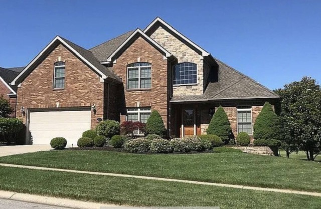 Family home with large deck with a beautiful view of golf course.
