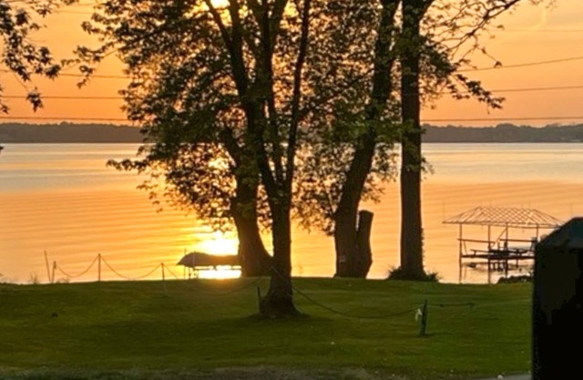 Lake-view retreat with dock access, firepits, & large yard