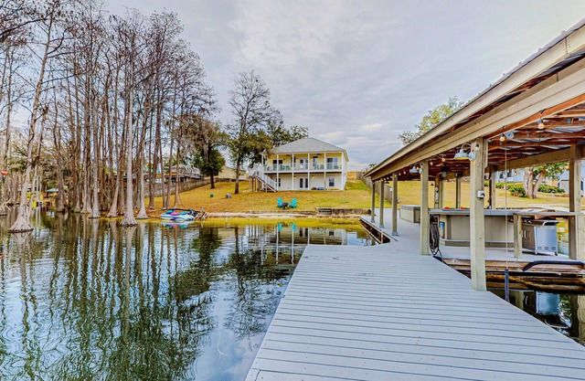 Lakefront home with amazing sunset/water view, private dock, & firepit