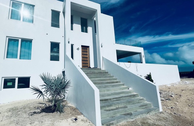 Modern 5-bedroom villa in Long Bay, steps from the beach, with private pool.