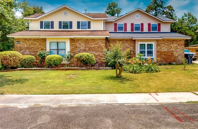 Modern home with a game room, washer/dryer, AC, covered patio, & large yard