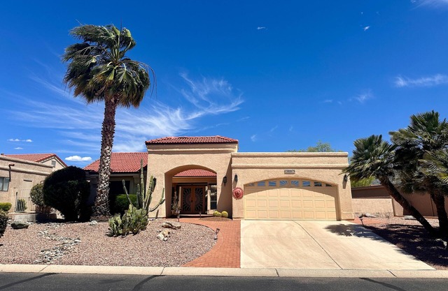 Mountain-view home with shaded patio, large yard, on-site golf & tennis