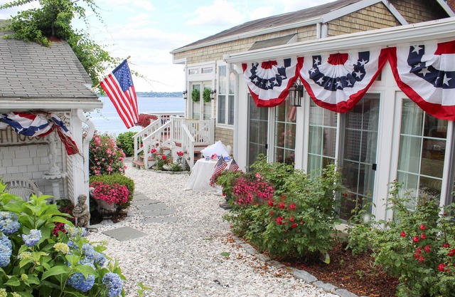 Old fashioned designer front porch living by the sea with expansive water views.