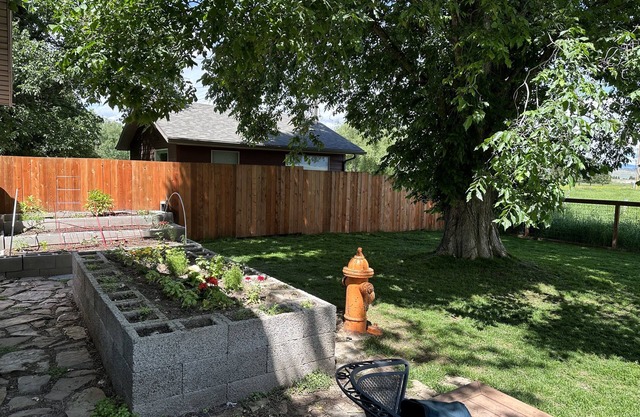 Pet friendly home with fenced yard, gardens and sauna one block from Main Street