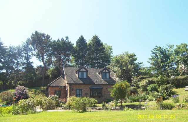 Seaview from bedroom, lounge and bathroom within an acre garden of tennis court