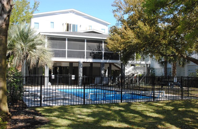 Second row home with private swimming pool, screened porch & deck located at North Litchfield Beach.