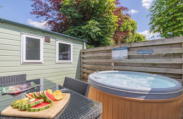 Spacious modern one-bedroom caravan exclusively for two adults with hot tub.