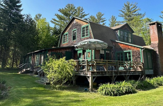 Spacious, rustic getaway on Caspian Lake with two docks & lawn.