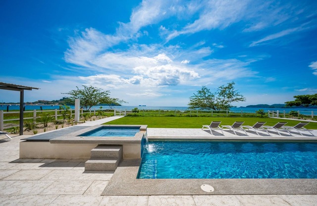 Spacious waterfront condo with shared pool, balcony, and washer/dryer