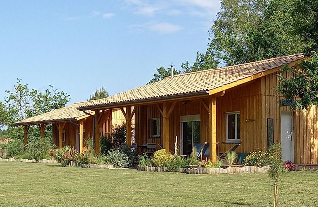 Three wooden houses with terraces near the ocean