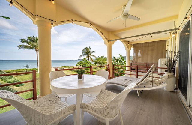 Tranquil beachfront condo with pool, balcony sunset views & fast Wi-Fi