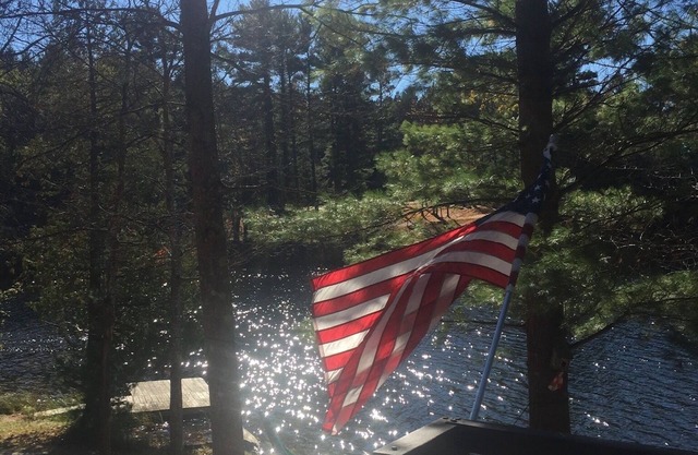Traverse City area Lakefront Log Home, FREE Hot Tub, WIFI, & Boats.