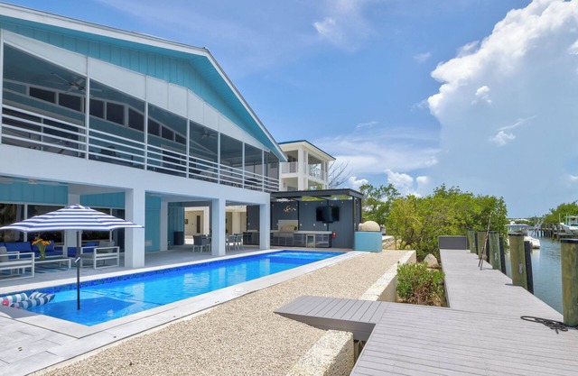 Waterfront bayside oasis w/dock, pool, outdoor kitchen, pizza oven & fun