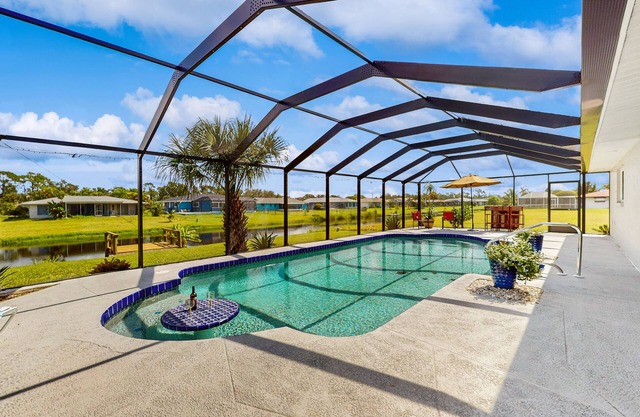 Waterfront retreat with in ground pool, outdoor patio, gas grill, and wifi