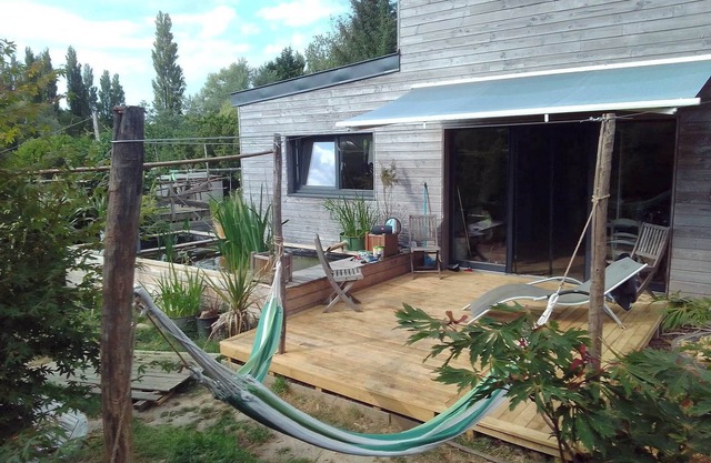 Wooden house between sea and countryside